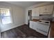 Galley kitchen with white cabinets and laminate flooring at 1360 Prescott S St, St Petersburg, FL 33712