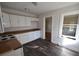 Efficient kitchen featuring white cabinets and laminate flooring at 1360 Prescott S St, St Petersburg, FL 33712