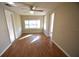 Living room with hardwood floors, large window, and ceiling fan at 1360 Prescott S St, St Petersburg, FL 33712