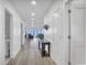 Bright hallway with light wood floors and view of living area at 1750 Jamaica Way # 0234, Punta Gorda, FL 33950