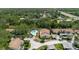 A tranquil community aerial view showcases a shared pool, lush trees, and well-maintained residential homes at 1808 Cypress Trace Dr # 1808, Safety Harbor, FL 34695