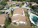Overhead view of the property, community pool, and landscaped surroundings in a tranquil neighborhood at 1808 Cypress Trace Dr # 1808, Safety Harbor, FL 34695