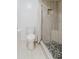 Updated bathroom featuring a white toilet and tiled shower with a shower curtain and stone tile base at 1808 Cypress Trace Dr # 1808, Safety Harbor, FL 34695