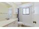 Bright bathroom featuring a tile shower, white vanity with solid surface top, and a large frameless mirror at 1808 Cypress Trace Dr # 1808, Safety Harbor, FL 34695