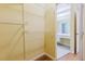 Walk-in closet with shelving and view to vanity area in bathroom at 1808 Cypress Trace Dr # 1808, Safety Harbor, FL 34695