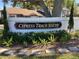Community sign surrounded by lush green plants and mulch at 1808 Cypress Trace Dr # 1808, Safety Harbor, FL 34695