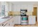 Modern kitchen featuring white cabinets, stainless steel appliances, and granite countertops at 1808 Cypress Trace Dr # 1808, Safety Harbor, FL 34695