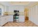 Bright kitchen features white cabinets, stainless steel appliances, tile flooring, and granite countertops at 1808 Cypress Trace Dr # 1808, Safety Harbor, FL 34695