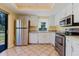 Well-lit kitchen featuring stainless steel appliances, ample counter space, and tile flooring at 1808 Cypress Trace Dr # 1808, Safety Harbor, FL 34695