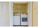 Convenient laundry area features modern washer and dryer units and shelving at 1808 Cypress Trace Dr # 1808, Safety Harbor, FL 34695