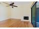 Cozy living room boasts hardwood floors, fireplace, and sliding door access at 1808 Cypress Trace Dr # 1808, Safety Harbor, FL 34695