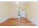 Bright, expansive living room with hardwood floors and an open view to an adjacent bathroom at 1808 Cypress Trace Dr # 1808, Safety Harbor, FL 34695