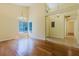 Open living area with wood floors, plenty of light from the windows and view of the adjacent dining room at 1808 Cypress Trace Dr # 1808, Safety Harbor, FL 34695