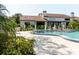 Inviting pool surrounded by lounge chairs and lush landscaping with a well-maintained building in the background at 1808 Cypress Trace Dr # 1808, Safety Harbor, FL 34695