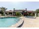 Community pool and spa area with lounge chairs, surrounded by a fenced yard at 1808 Cypress Trace Dr # 1808, Safety Harbor, FL 34695