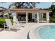 Community pool house with bar seating, ceiling fans, and lounging chairs at 1808 Cypress Trace Dr # 1808, Safety Harbor, FL 34695