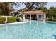 Community pool area with lounge chairs and covered seating at 1808 Cypress Trace Dr # 1808, Safety Harbor, FL 34695