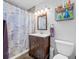 Bathroom featuring a vanity with a dark wood finish and a shower with tiled walls at 1900 60Th N Way, St Petersburg, FL 33710