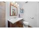 Updated bathroom featuring wood vanity, framed mirror, and a neutral color scheme at 1900 60Th N Way, St Petersburg, FL 33710