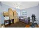 Bedroom with hardwood floors, a window with view, and a stack of boxes at 1900 60Th N Way, St Petersburg, FL 33710
