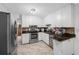 Bright kitchen featuring white cabinets, granite countertops, and stainless steel appliances at 1900 60Th N Way, St Petersburg, FL 33710