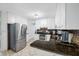 Well-maintained kitchen with white cabinets, dark granite countertops, and stainless steel appliances at 1900 60Th N Way, St Petersburg, FL 33710