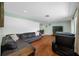 Comfortable living room featuring a large sectional sofa, hardwood floors, and a modern television at 1900 60Th N Way, St Petersburg, FL 33710