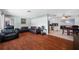 Well-lit living room with hardwood floors, a sectional sofa, and an adjacent dining area at 1900 60Th N Way, St Petersburg, FL 33710
