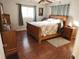 Spacious main bedroom with wood flooring and a sleigh bed at 1900 60Th N Way, St Petersburg, FL 33710