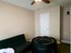 Bedroom with a futon, pet enclosure, and ample floor space at 2302 Maki Rd # 62, Plant City, FL 33563