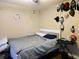 Cozy bedroom with a white bed frame and various wall decor at 2302 Maki Rd # 62, Plant City, FL 33563