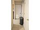Home hallway with tile flooring and a large trash can at 2302 Maki Rd # 62, Plant City, FL 33563
