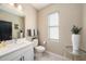 Modern bathroom with white vanity, quartz countertop, and a toilet at 2511 N Grady Ave # 55, Tampa, FL 33607