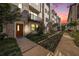 Modern townhome exterior at dusk, showing landscaping and walkway at 2511 N Grady Ave # 55, Tampa, FL 33607