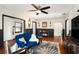 Living room with hardwood floors, blue velvet couch, and ceiling fan at 3510 1St S Ave, St Petersburg, FL 33711