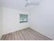 Spacious bedroom featuring a large window and laminate floors at 3900 107Th N Ave, Clearwater, FL 33762