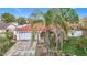 Single-Gathering house with red tile roof, white walls, and a garage at 4740 114Th N St, St Petersburg, FL 33708
