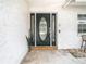 Dark green front door with glass panels and sidelights at 4740 114Th N St, St Petersburg, FL 33708