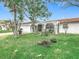 Exterior of a house with a large yard and palm trees at 4740 114Th N St, St Petersburg, FL 33708