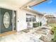 Front entrance with a dark green door and a small patio at 4740 114Th N St, St Petersburg, FL 33708
