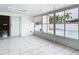Bright screened patio with pool view, tile floors, and sliding glass door access at 4740 114Th N St, St Petersburg, FL 33708