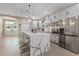 Bright kitchen featuring a large island, pendant lights, and stainless steel appliances at 636 Limona Woods Dr, Brandon, FL 33510