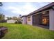 Screened patio and grassy backyard with raised garden bed at 7465 Yale Harbor Dr, Wesley Chapel, FL 33545