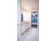 Double sink bathroom with granite countertops and a view into bedroom at 7465 Yale Harbor Dr, Wesley Chapel, FL 33545
