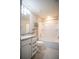 Clean bathroom with white bathtub, granite countertop, and shelves at 7465 Yale Harbor Dr, Wesley Chapel, FL 33545