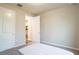 Well-lit bedroom featuring a door to a hallway and carpet flooring at 7465 Yale Harbor Dr, Wesley Chapel, FL 33545