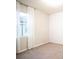 Bright bedroom with neutral walls, plush carpeting, and white curtains at 7465 Yale Harbor Dr, Wesley Chapel, FL 33545