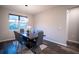 Elegant dining room with dark wood table and six gray chairs at 7465 Yale Harbor Dr, Wesley Chapel, FL 33545
