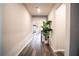 Long entry hallway with wood-look floors at 7465 Yale Harbor Dr, Wesley Chapel, FL 33545