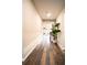 Long entry hallway with wood-look floors at 7465 Yale Harbor Dr, Wesley Chapel, FL 33545